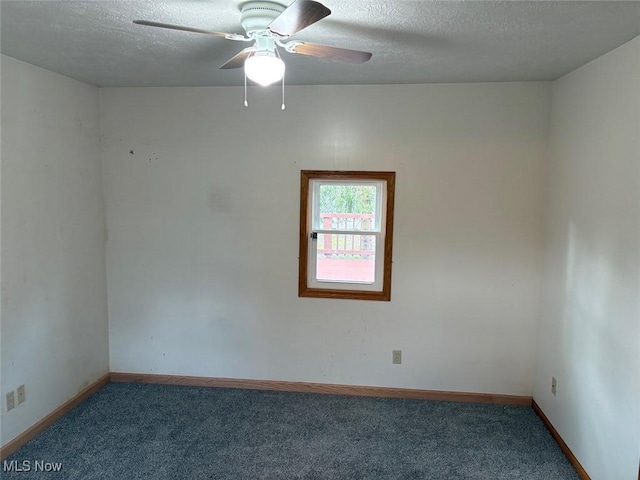 carpeted empty room featuring a textured ceiling, baseboards, and a ceiling fan