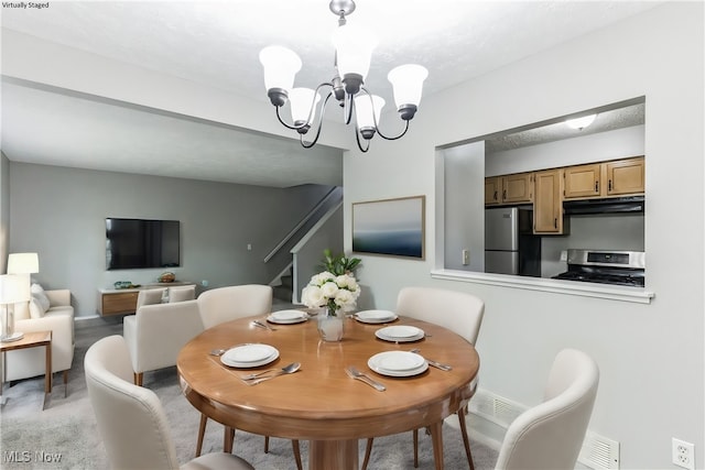 dining area with an inviting chandelier, stairs, light colored carpet, and visible vents