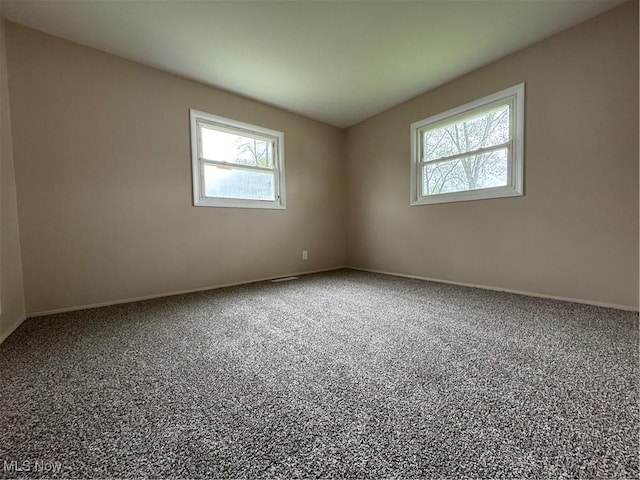 carpeted spare room with baseboards