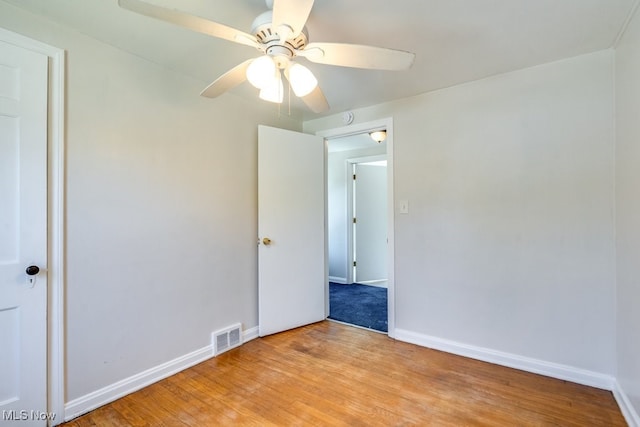 unfurnished bedroom with light wood-type flooring, visible vents, baseboards, and ceiling fan