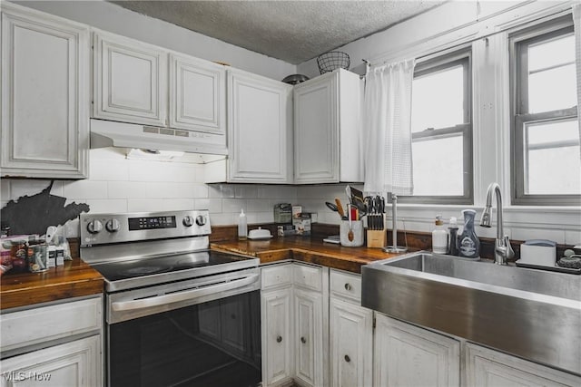 2007 Carson St, Charleston, WV 25302 - kitchen featuring stainless steel range with electric stovetop, a sink, a textured ceiling, under cabinet range hood, and butcher block counters