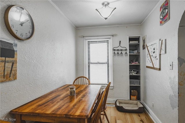 2007 Carson St, Charleston, WV 25302 - dining area featuring baseboards, ornamental molding, a textured wall, and wood finished floors