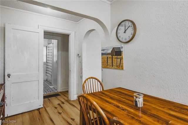 2007 Carson St, Charleston, WV 25302 - dining space with crown molding, a textured wall, arched walkways, and light wood-type flooring