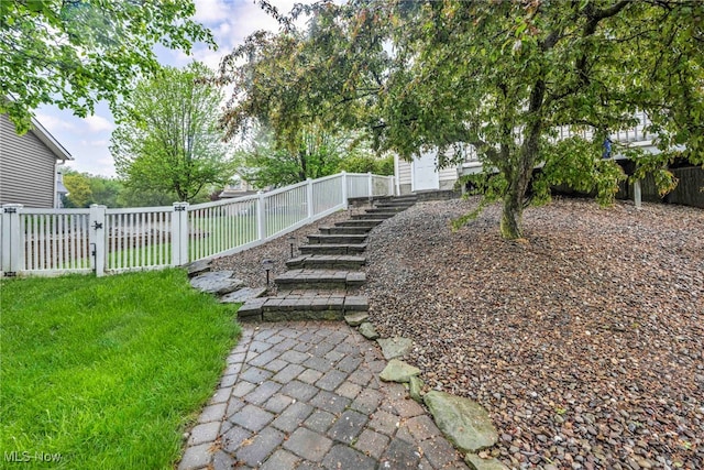 view of yard featuring stairs and a fenced backyard