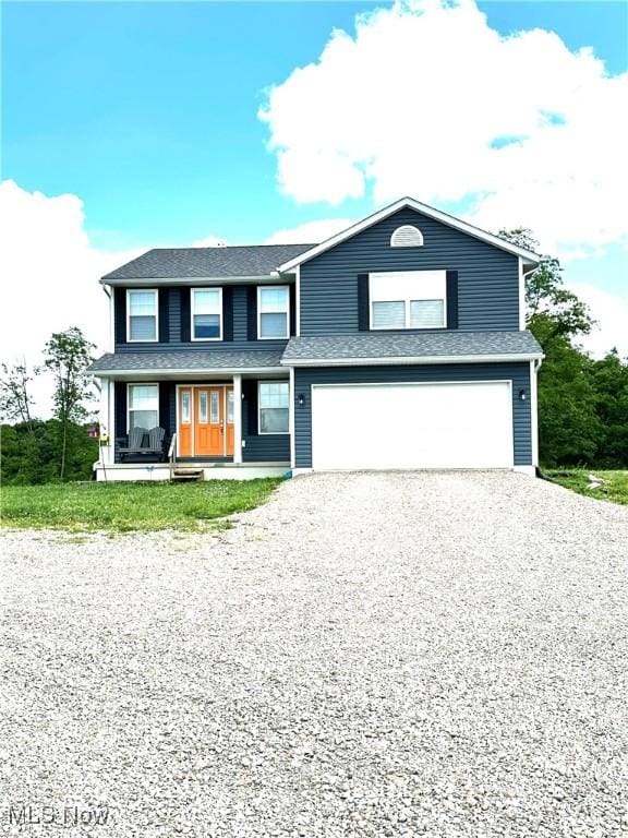 11149 Rankin Rd, Glenford, OH 43739 - view of front of property with driveway, a garage, and a porch