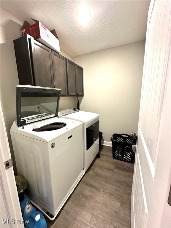 11149 Rankin Rd, Glenford, OH 43739 - laundry room with cabinet space, washer and dryer, wood finished floors, and baseboards