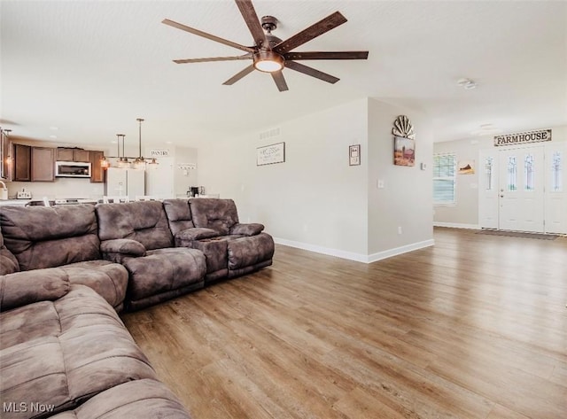 11149 Rankin Rd, Glenford, OH 43739 - living area with a ceiling fan, light wood finished floors, and baseboards