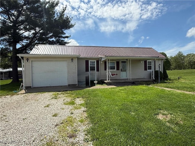ranch-style house with covered porch, metal roof, an attached garage, and a front yard