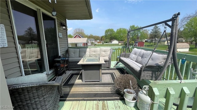 balcony with an outdoor living space with a fire pit
