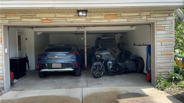 garage featuring concrete driveway