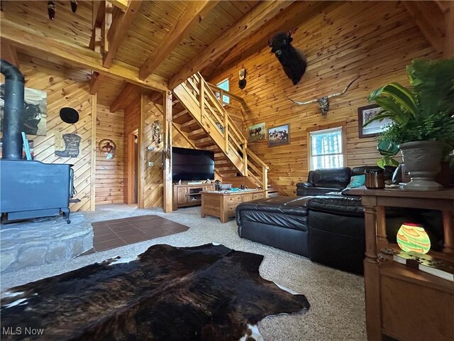 165 Township Rd Unit 1461, Greenwich, OH 44805 - living room featuring a wood stove, wood walls, vaulted ceiling with beams, and carpet floors