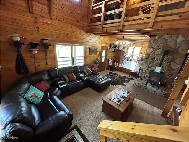 165 Township Rd Unit 1461, Greenwich, OH 44805 - carpeted living room featuring a wood stove, wooden walls, a wealth of natural light, and high vaulted ceiling