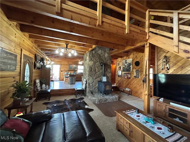 165 Township Rd Unit 1461, Greenwich, OH 44805 - living room with a wood stove, beam ceiling, wooden walls, and carpet floors