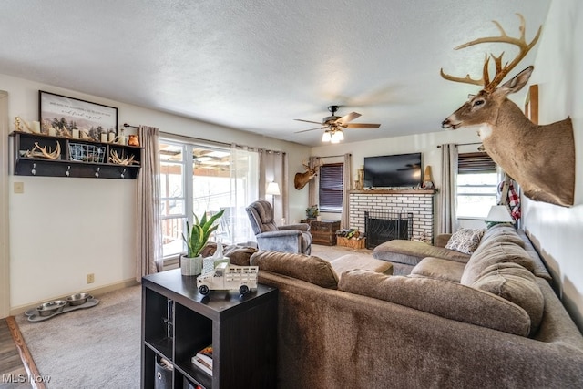 396 2nd St NE, Carrollton, OH 44615 - living room with plenty of natural light, a fireplace, ceiling fan, carpet, and a textured ceiling