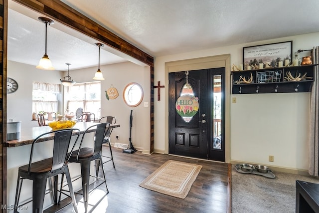 396 2nd St NE, Carrollton, OH 44615 - entrance foyer featuring dark wood finished floors, beam ceiling, and baseboards