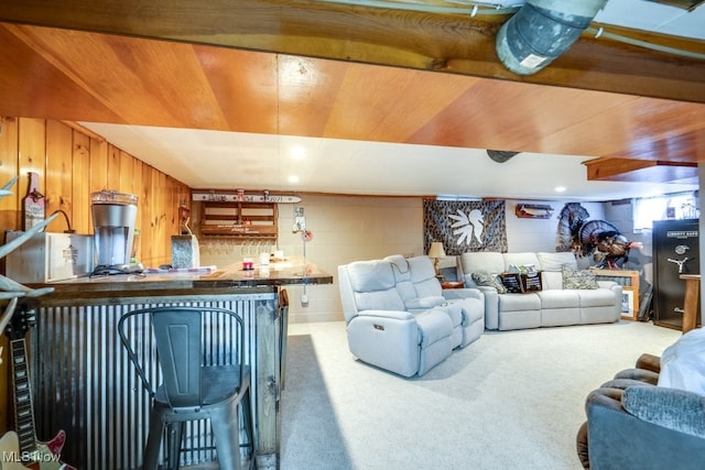 396 2nd St NE, Carrollton, OH 44615 - carpeted living room with bar, wood ceiling, and concrete block wall