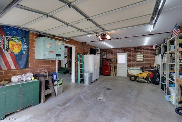 396 2nd St NE, Carrollton, OH 44615 - garage with white refrigerator with ice dispenser and a garage door opener