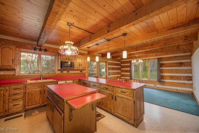 6570 State Route 339, Vincent, OH 45784 - kitchen with a center island, wooden ceiling, a sink, stainless steel microwave, and beamed ceiling