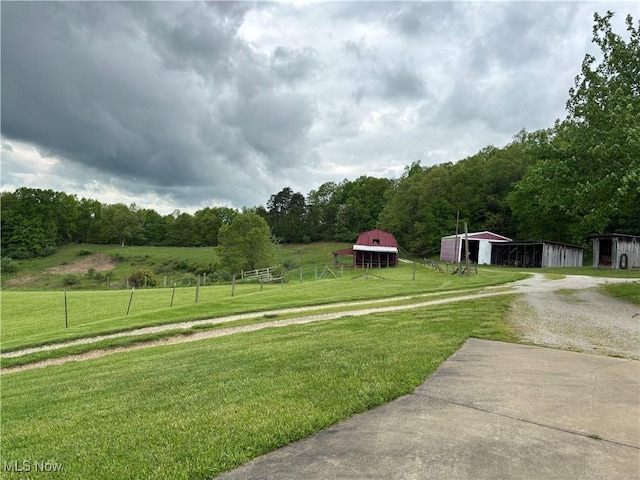 212 Rost Rd, Walker, WV 26180 - view of yard featuring driveway, an outbuilding, and a wooded view