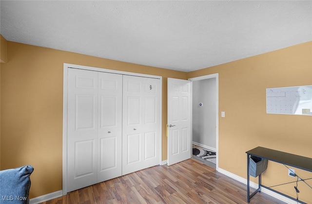 home office featuring wood finished floors and baseboards