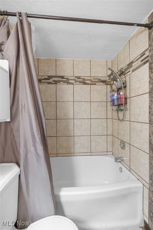 bathroom with toilet and shower / bath combo