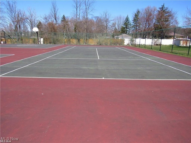 view of tennis court with fence and community basketball court