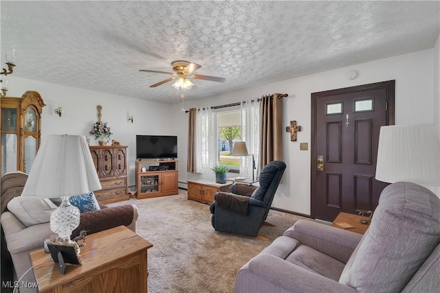 living area with a textured ceiling, ceiling fan, light colored carpet, and baseboard heating