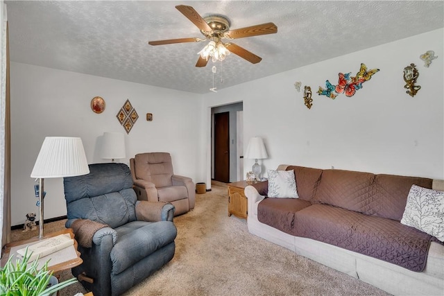 living room with light colored carpet, ceiling fan, and a textured ceiling