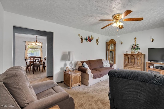 living area featuring a chandelier, light carpet, a ceiling fan, and a textured ceiling