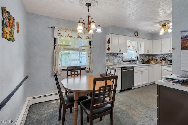 carpeted dining area with plenty of natural light, a sink, a ceiling fan, a textured ceiling, and a chandelier