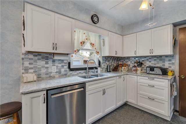 kitchen with dishwasher, a sink, white cabinets, and backsplash