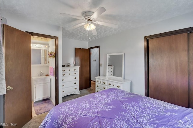 carpeted bedroom featuring a closet, connected bathroom, and a ceiling fan