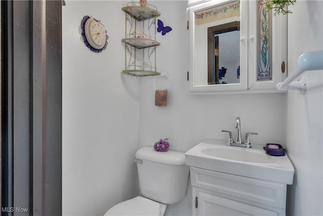 bathroom featuring toilet and vanity