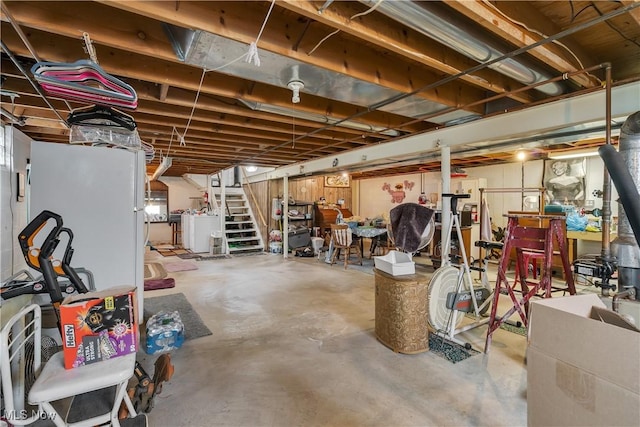 unfinished below grade area with stairway and washer / dryer