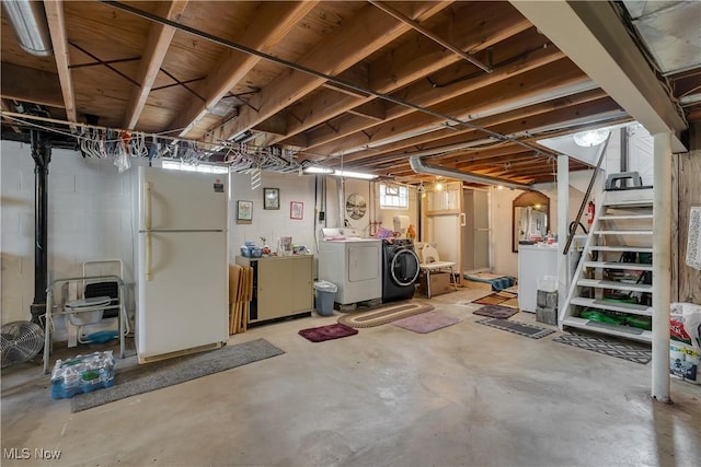 below grade area with freestanding refrigerator, washing machine and clothes dryer, and stairway