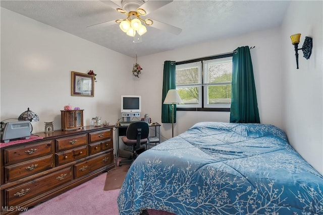 carpeted bedroom featuring a desk and ceiling fan