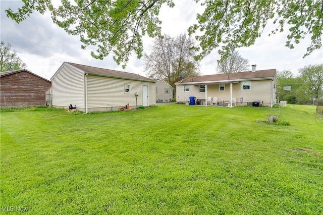 back of house with a yard and central AC unit