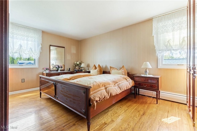 8295 Mentorwood Dr, Mentor, OH 44060 - bedroom featuring multiple windows, light wood finished floors, and baseboards