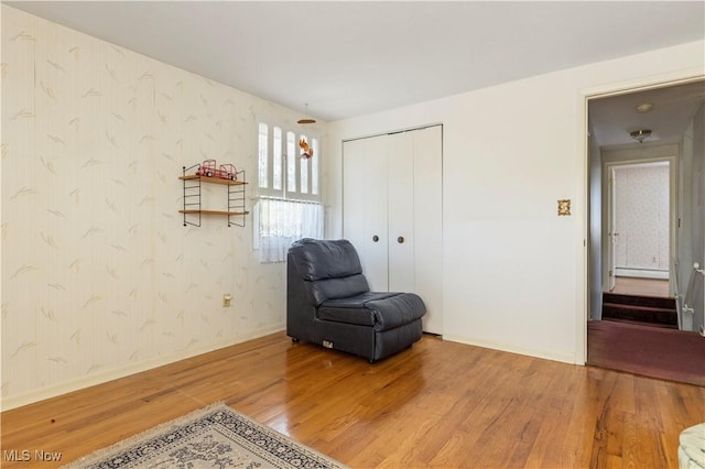 8295 Mentorwood Dr, Mentor, OH 44060 - living area with wood finished floors, wallpapered walls, a baseboard heating unit, and baseboards