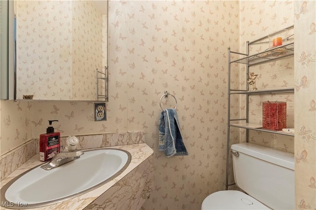 8295 Mentorwood Dr, Mentor, OH 44060 - bathroom with wallpapered walls, a sink, and toilet