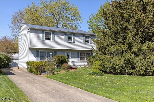8295 Mentorwood Dr, Mentor, OH 44060 - colonial house with a front lawn, an outdoor structure, and a detached garage