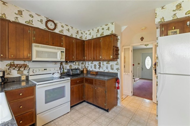 8295 Mentorwood Dr, Mentor, OH 44060 - kitchen featuring white appliances, wallpapered walls, dark countertops, and brown cabinetry