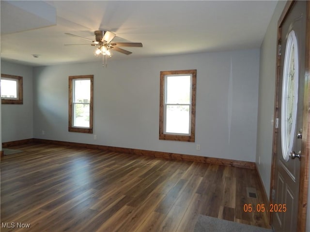 unfurnished room with wood finished floors, baseboards, and a ceiling fan