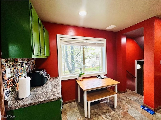 741 Jennings Ave, Salem, OH 44460 - kitchen with green cabinets, light stone finish floors, and baseboards