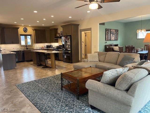 living area featuring ceiling fan and recessed lighting