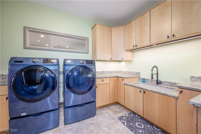 washroom featuring washer and clothes dryer and cabinet space