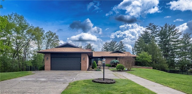 ranch-style house featuring concrete driveway, an attached garage, and brick siding