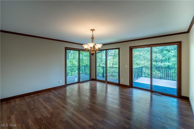 spare room featuring a chandelier, crown molding, baseboards, and dark wood-style flooring