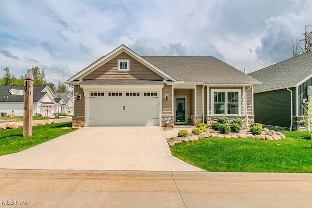 craftsman-style house featuring stone siding, driveway, a front yard, and an attached garage