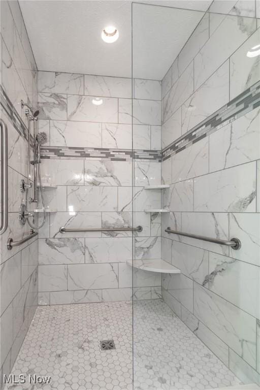 bathroom with a tile shower